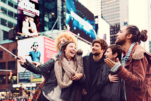 Group of friends making selfie in Time Square