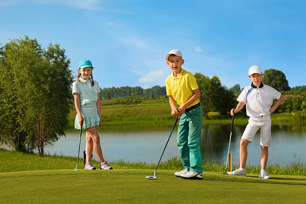 Kids playing golf stock photo