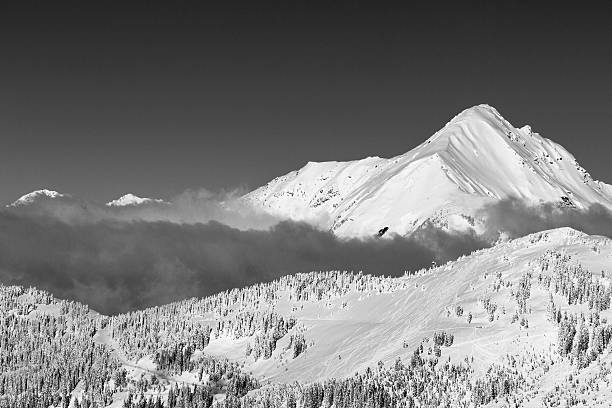 istock Moody skies with snowy mountain peaks poking through clouds 511368732
