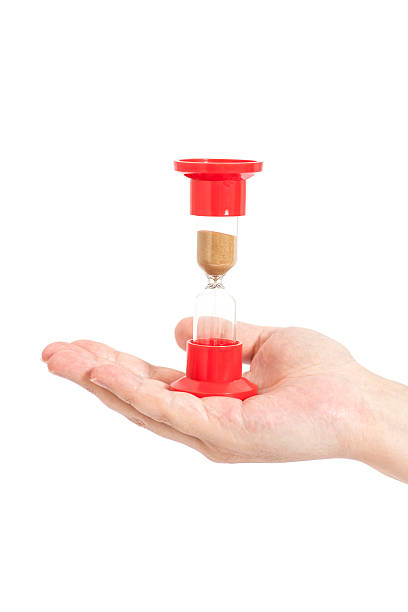 istock Man hand holding hourglass Isolated on white 511373214