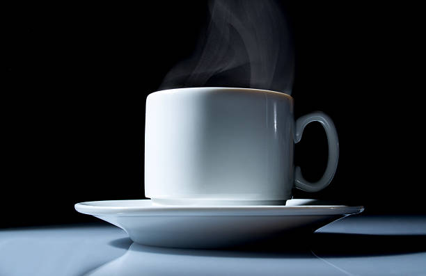 istock cup of coffee with smoke close up on  black 511374126
