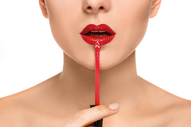 istock Beautiful female lips with make-up and brush 511374514