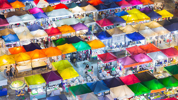 istock Night lights multiple colours roof top of flea market 511374852
