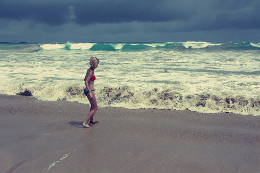 girl afraid of stormy ocean, Galapagos