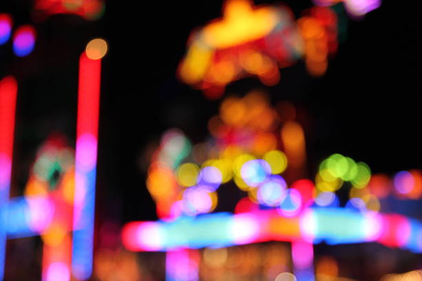 Blurred lights of a fairground carousel against a black background