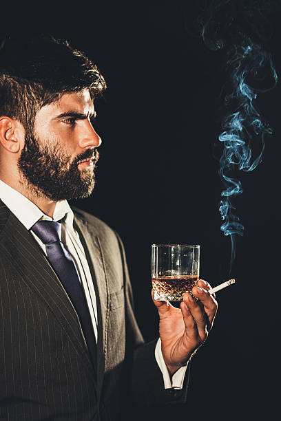 istock Man with a glass of whiskey and cigarette 511375454