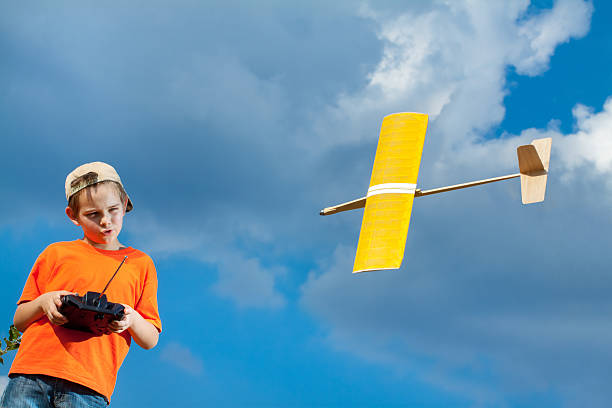 istock Little boy playing with handmade RC airplane toy 511378010