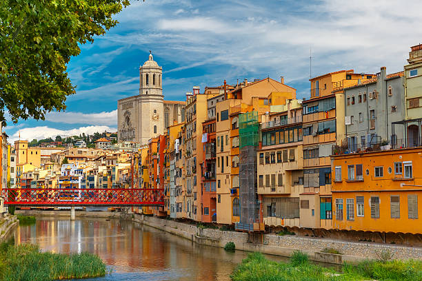 Colorful houses in Girona, Catalonia, Spain Colorful yellow and orange houses and Eiffel Bridge, Old fish stalls, reflected in water river Onyar, in Girona, Catalonia, Spain. Saint Mary Cathedral at background. old town stock pictures, royalty-free photos & images