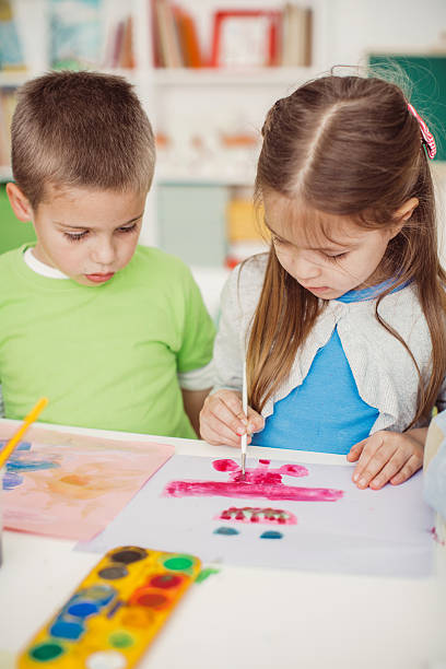 istock Little painters at work in the playroom 511379212