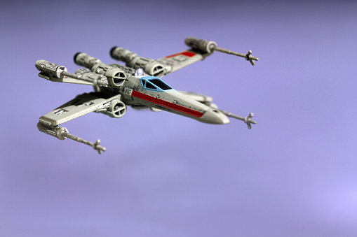 Vancouver, Canada - January 25, 2016: An X-Wing from the Star Wars film franchise against a misty background. The X-Wing is from the X-Wing Minatures game by Final Flight Games.