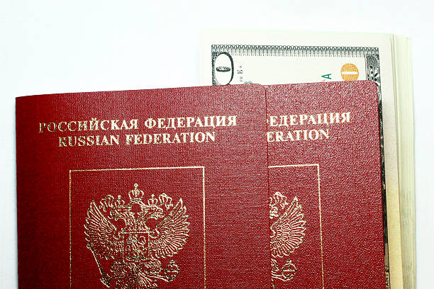istock Russian Passport And Dollars USA Isolated On White Background 511382394