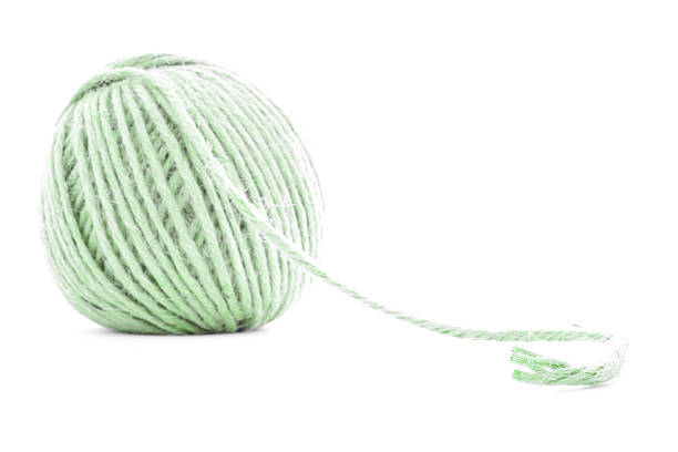 istock Green braided clew, knitting yarn roll isolated on white background 511383922