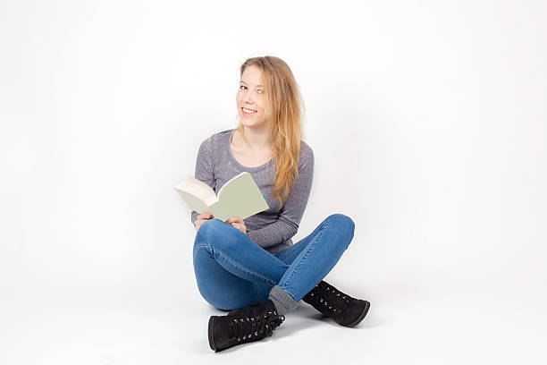 istock Cute girl sitting with a book 511386972