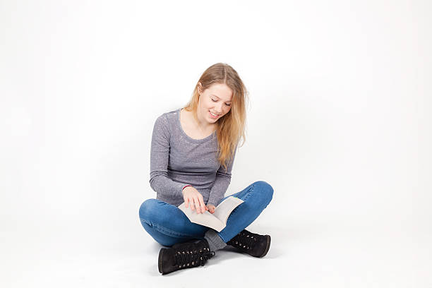 istock Cute girl sitting with a book 511387120