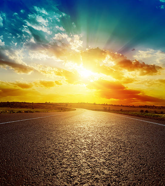 istock orange sunset over asphalt road 511387281