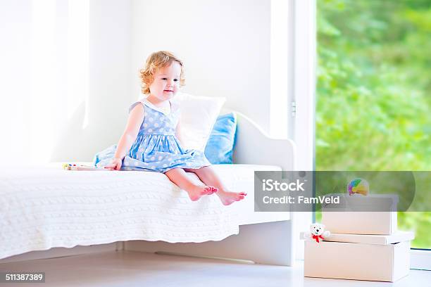 Little Girl Reading A Book Stock Photo - Download Image Now - Baby - Human Age, Bed - Furniture, Bedroom