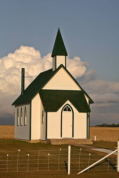 istock Thunderhead clouds forming behind a country church 511387625