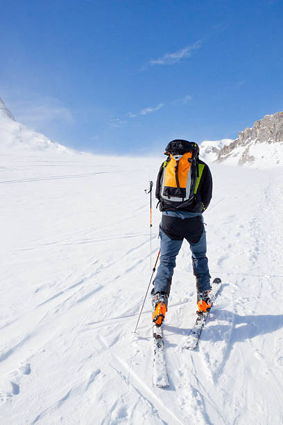 istock touring skier going up of a mountain 511387824