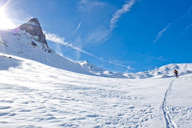 istock skier going up of a mountainin a sunny day 511387844