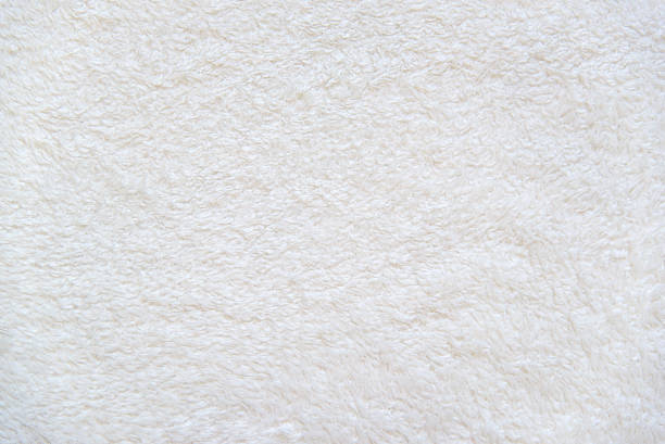 White background of plush fabric Beige background of plush fabric ivory material stock pictures, royalty-free photos & images