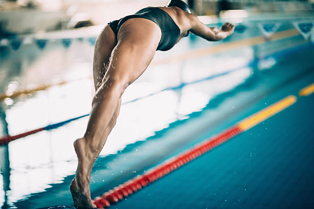istock Swimming race start, swimmer jumping into the pool 511389292