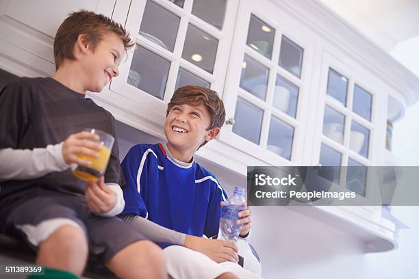 Discussing The Game Over Some Hardearned Refreshment Stock Photo - Download Image Now