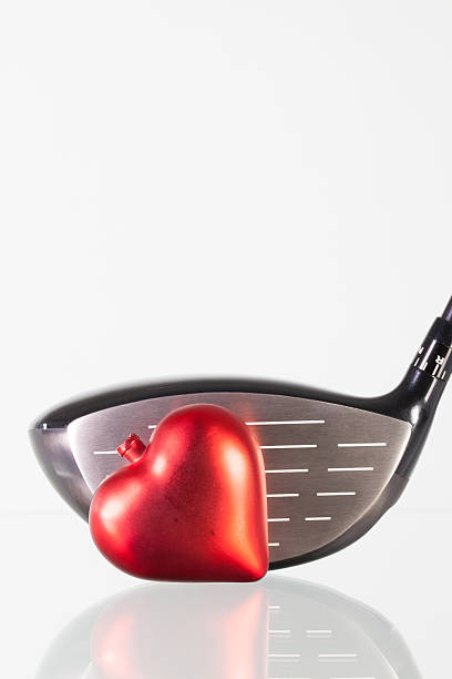 istock Golf club and red heart on a glass table 511389648