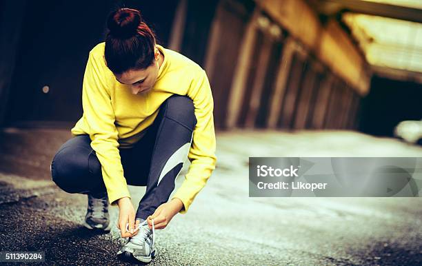 Young Woman Preparing For A Run Stock Photo - Download Image Now - Autumn, Relaxation Exercise, 20-29 Years