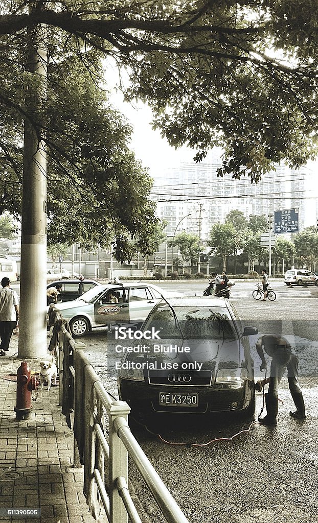 Local family street corner carwash business, early morning, Shanghai, China. Shanghai, China - July 6, 2011: Local family street corner carwash business, early morning, Shanghai, China. 2011 Stock Photo