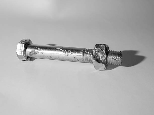 istock Defective metric bolt with nut closeup against a dark background 511391302