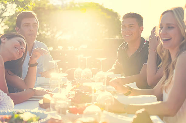 istock Group of young people eating outdoors. 511391714