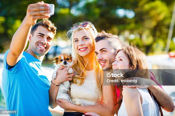 Friends With Dog Taking Group Selfie With Smart Phone Stock Photo - Download Image Now