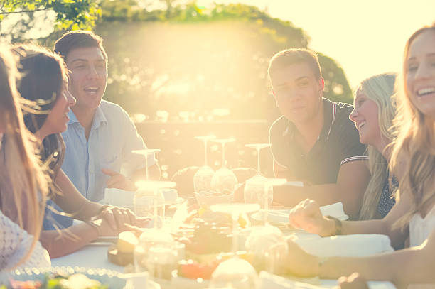 istock Group of young people eating outdoors. 511392006