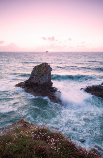 Trevellas porth island during a storm and sunset in cornwall, uk england kernow