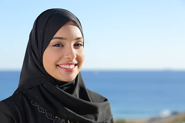 Beautiful arab saudi woman face posing on the beach Beautiful arab saudi woman face posing on the beach with the sea in the background arabic girl stock pictures, royalty-free photos & images
