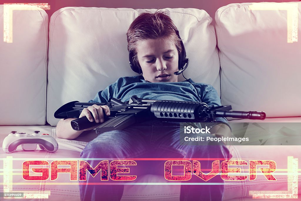 Warning: Not suitable for children An image of a boy sleeping on the sofa after playing a violent video gamehttp://195.154.178.81/DATA/i_collage/pi/shoots/783805.jpg Game Over - Short Phrase Stock Photo