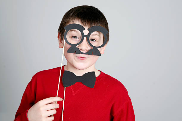 istock Kid with fake mustache and glasses 511435771