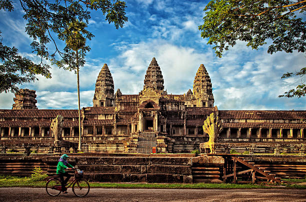 istock Angkor Wat Temple Side View Bicycle Rider at Sunrise, Cambodia 511436385
