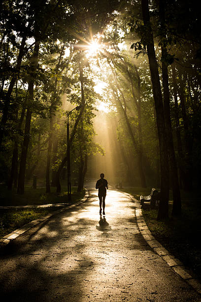 istock Girl jogging in park 511436551
