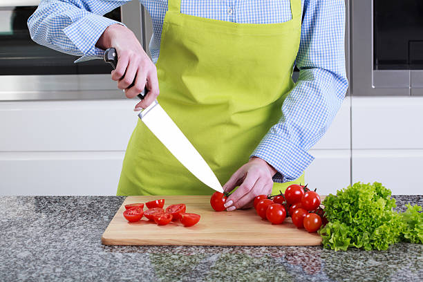 istock Housewife cut small red tomatoes 511436657