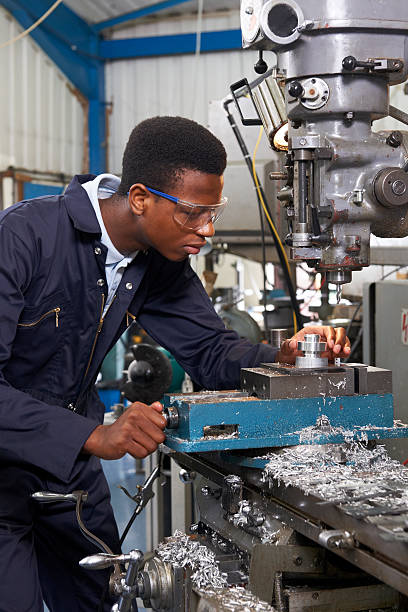 istock Male Apprentice Engineer Working On Drill In Factory 511437173