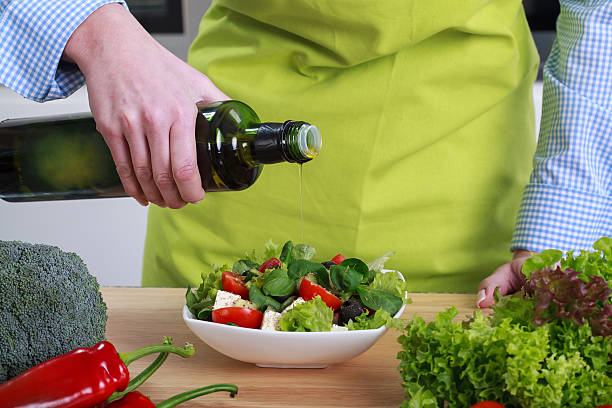 istock Housewife pours olive salad 511437225