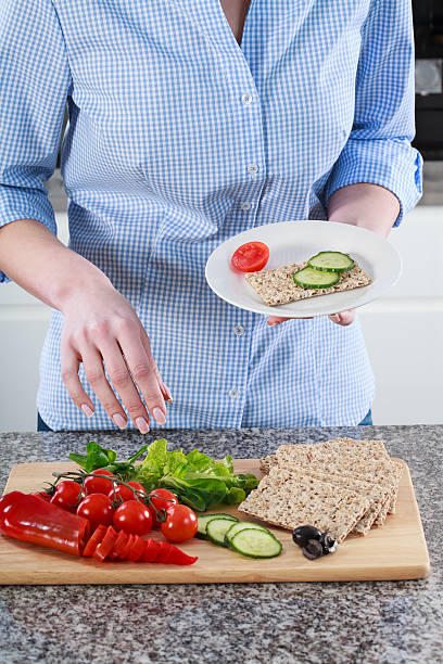 istock Housewife preparing a healthy sandwich 511437373