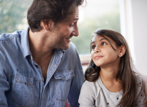 Shot of a father and daughter bonding indoors