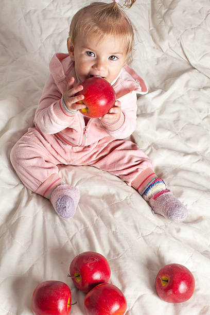 istock Little girl with apples. 511440125