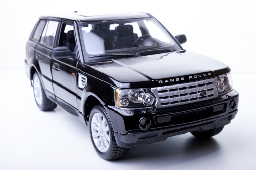 Beaconsfield, UK - September 6, 2014: A model of a black Range Rover Sport against a bright white background.