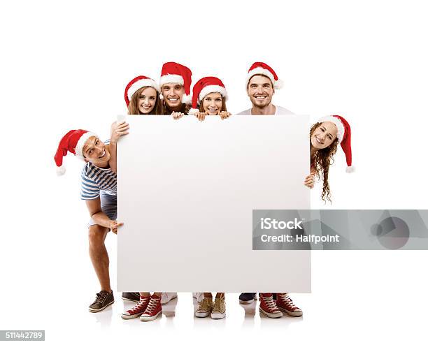 Young People In Santa Hats Stock Photo - Download Image Now - Adult, Advertisement, Banner - Sign