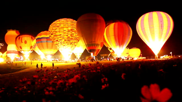 Hot air balloons at night.