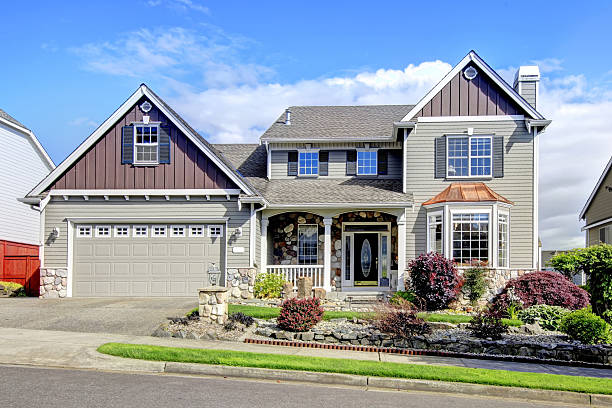 istock Modern home with navy blue door and decorative front yard. 511457052