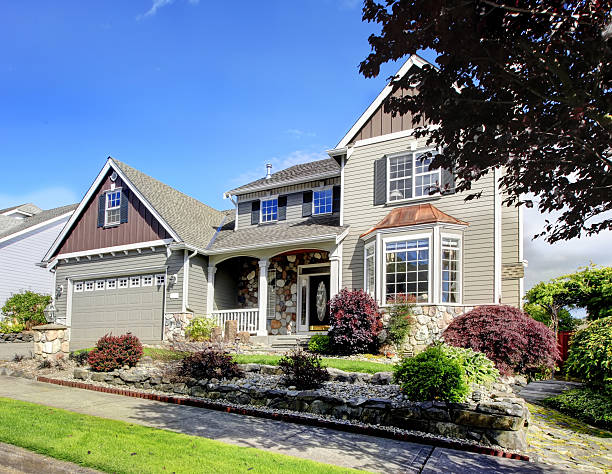 istock Modern home with navy blue door and decorative front yard. 511457092
